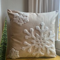 a white pillow sitting on top of a yellow chair