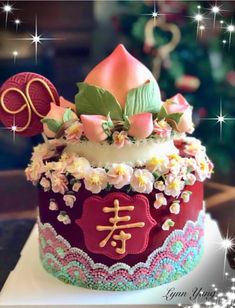 there is a cake decorated with flowers and hearts on the top of it, along with other decorations