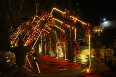 A customised entry porch created for a sangeet ceremony, decorated with led lights and flowers. Sangeet Entry Passage Decor, Sangeet Stage Decor With Led Screen, Sangeet Entry Decor, Wedding Entry Decoration, Passage Decor Wedding, Event Entry Gate Design, Wedding Stage Decorations Elegant Classy, Marriage Entry Gate Decoration, Sangeet Entrance Decor