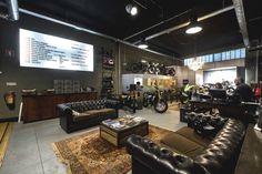 a motorcycle shop with leather couches and motorcycles