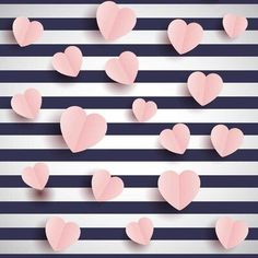 pink paper hearts are floating in the air on a striped background with black and white stripes