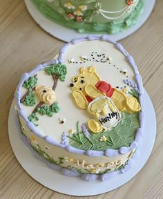 two winnie the pooh birthday cakes on plates