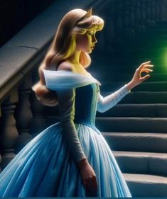 a woman in a blue dress is holding a green light up ball on some steps