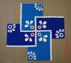 two pieces of blue and white rugs with flowers on the top one is made out of felt