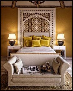 a large bed with yellow pillows in a bedroom next to two lamps on either side of the bed