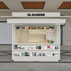 a display case in the middle of a building with books on it's shelves