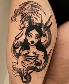 a woman with a dragon tattoo on her thigh