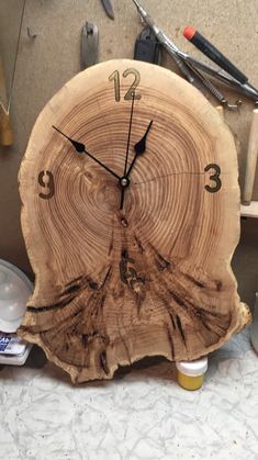 a clock made out of a piece of wood