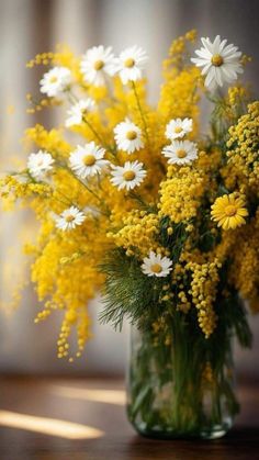 a vase filled with yellow and white flowers