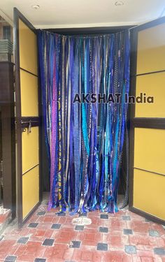 the entrance to an office building with blue and purple streamers hanging from it's walls