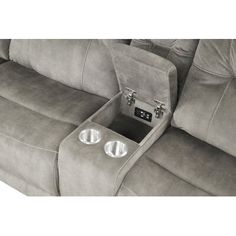 the back end of a reclining couch with two cup holders on it's arm