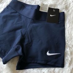 a pair of nike shorts on top of a white furnishing area with a tag attached to it