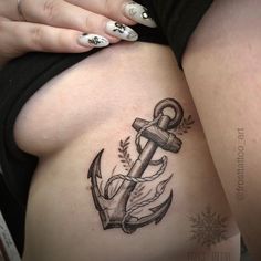 a woman's thigh with an anchor tattoo on it