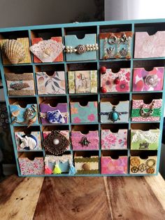 a wooden table topped with drawers filled with lots of different types of cards and magnets