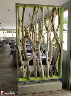 the interior of a restaurant with tables, chairs and trees in front of it's windows