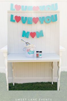 a sign that says i love you to the moon and back on a white bench