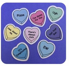 six heart shaped stickers with words on them