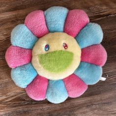 a colorful flower shaped brooch sitting on top of a wooden table