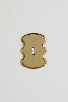 a single light switch cover in gold