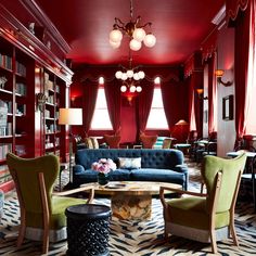 a living room filled with furniture and red walls