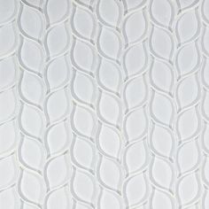 an abstract white tile pattern with wavy lines and curved circles on the bottom half of it