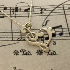 a musical note with a treble in the shape of a heart on top of sheet music