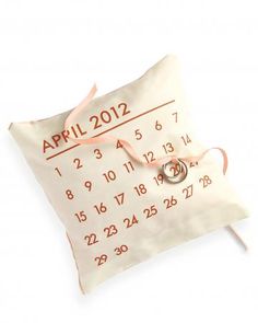 a pillow with a ring on it and the date for april 2012 printed on it