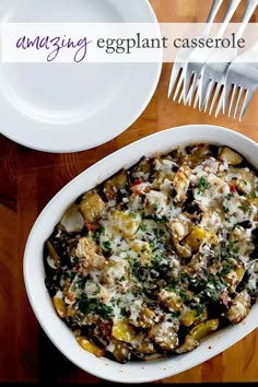 a casserole dish on a wooden table with silverware