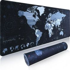 a black and white world map on a wall next to a rolled up mat with a roll of fabric