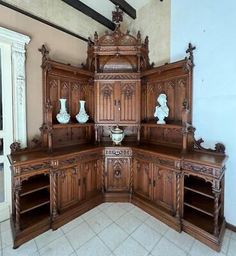 an ornate wooden cabinet in the corner of a room