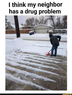 a person shoveling snow on the sidewalk with an orange duster in their hand