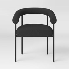 a black chair with a curved back and armrest, in front of a white background