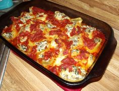 a square pizza sitting on top of a pan covered in cheese and tomato toppings