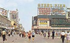 people walking down the street in front of some stores