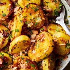 cooked potatoes with bacon and parsley in a serving dish