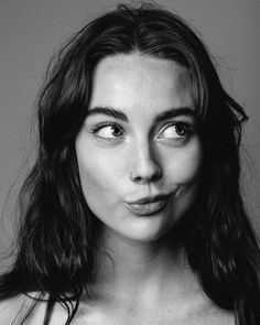 a black and white photo of a woman making a funny face