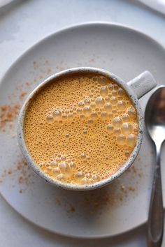 a cup of hot chocolate sits on a saucer