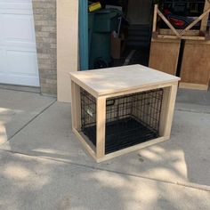 a dog crate sitting on the sidewalk in front of a garage