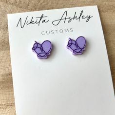 "These Love Yourself heart stud earrings are perfect for the BTS ARMY in your life! Sized at just over .5\" the studs are cut from a pastel lavender acrylic and then receive a purple color fill for the details.  The standard backs for these earrings are 99.9% pure titanium making them sensitive skin friendly. However, if you need alternative earring back options (like plastic studs) please reach out prior to placing your order, as we do have a few other options. Custom requests are welcome, so if you'd like this design in a different color combo please just send us a message! Be sure to check out Nikita Ashley Customs on Facebook, Instagram or our website - www.NikitaAshleyCustoms.com *All items are handmade so there may be small variations from piece to piece. Acrylic pieces can be fragil Trendy Purple Heart Earrings, Trendy Purple Heart Earrings As Gift, Trendy Purple Heart Earrings For Gift, Kpop Jewelry, Bts Earrings, Alternative Earrings, Merch Kpop, Pastel Lavender, Earring Ideas