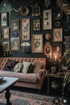 a living room filled with lots of pictures on the wall and a couch in front of it