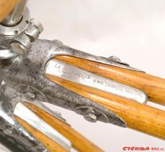 an old bicycle with wooden handlebars and metal parts