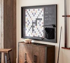 a room with a blackboard and some wooden stools in front of the wall