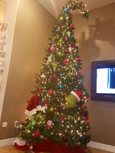 a decorated christmas tree in the corner of a room