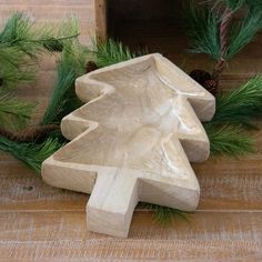 a small wooden christmas tree sitting on top of a table