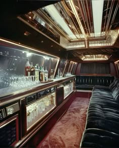 the inside of a limo with several liquor bottles and glasses on it's glass shelves