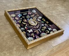 an ornately decorated tray on the floor with beads and jewels in it's center