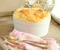 a close up of a casserole dish on a table with utensils