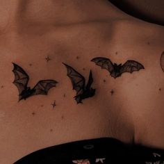 a man's chest with three bats flying in the sky and stars on it