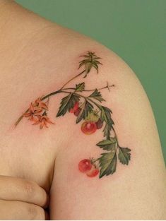 a woman's shoulder with flowers and leaves on it