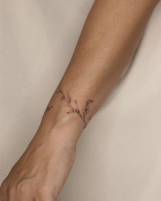 a person's arm with a small tattoo on it